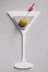 Silhouette of a martini cocktail made with cardboard with real olive