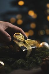 Man holding Christmas gift in hands