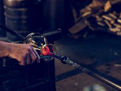Crop craftsman shaping vase from glass