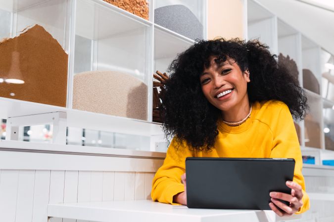 Black female using tablet against wall