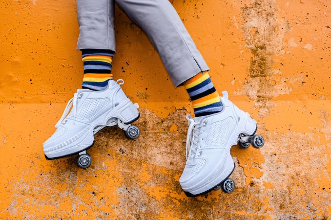 Person’e legs wearing colorful socks and roller skates
