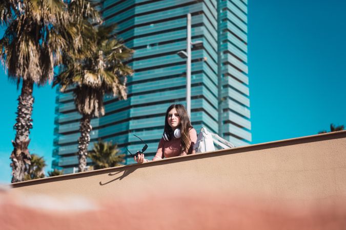 Teen girl watching the street while listening to music.