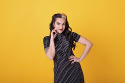 pin-up girl posing to the camera over yellow background.