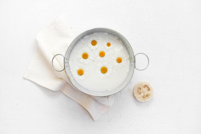 Top view of chamomile milk for at-home spa treatment