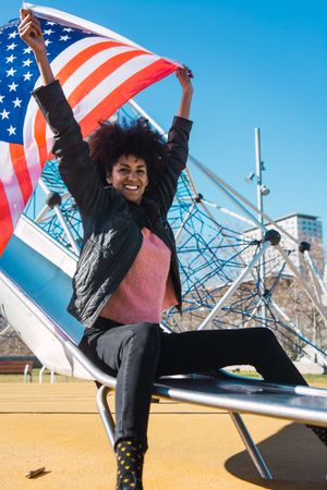 Black woman with afro hair and an american flag.