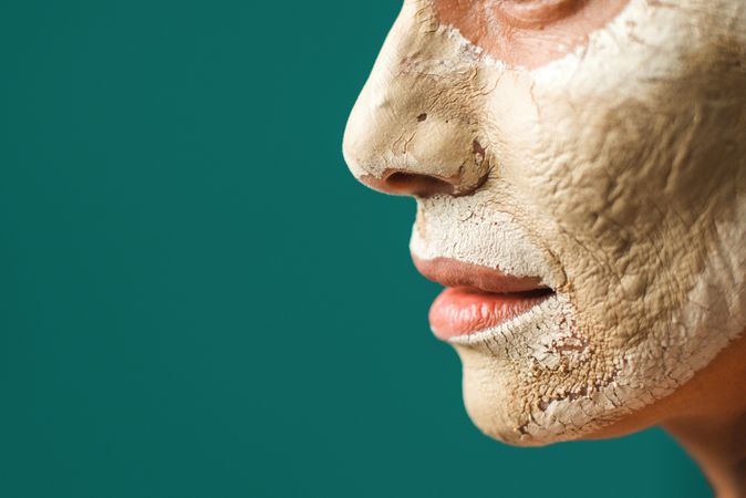 Crop woman with clay mask