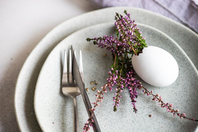 Heather in decorative egg on grey plate for Easter dinner