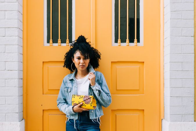 Stylish female by yellow door