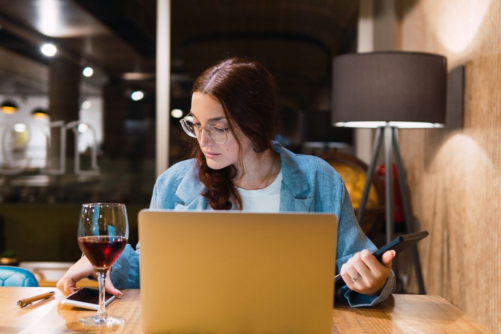 Focused female freelancer working in restaurant
