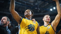 Happy Diverse Sports Team Victorious at Basketball Association Playoffs: Group of Players Celebrate the Victory Together with a Coach.
