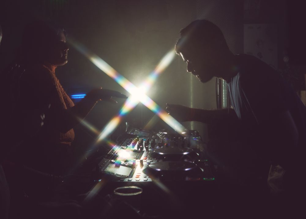 London, England, United Kingdom - Nov 9, 2022: Side view of man DJ-ing with flare