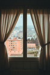 View of city through window from flat