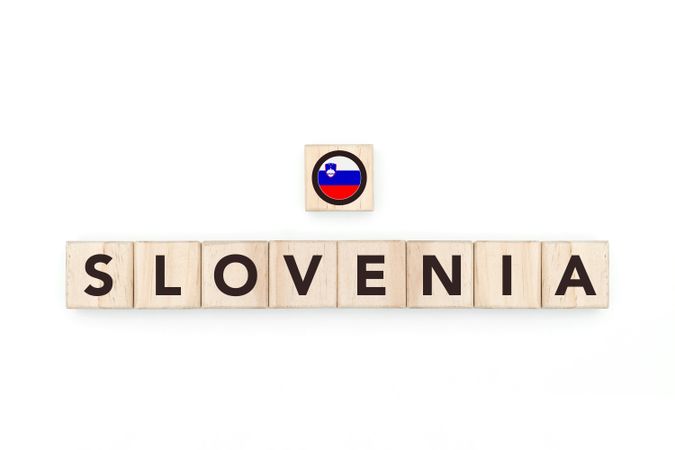Wooden blocks bearing the name and flag of Slovenia. Sloven and East European Culture, national identity, travel, and geography in a copy space design.