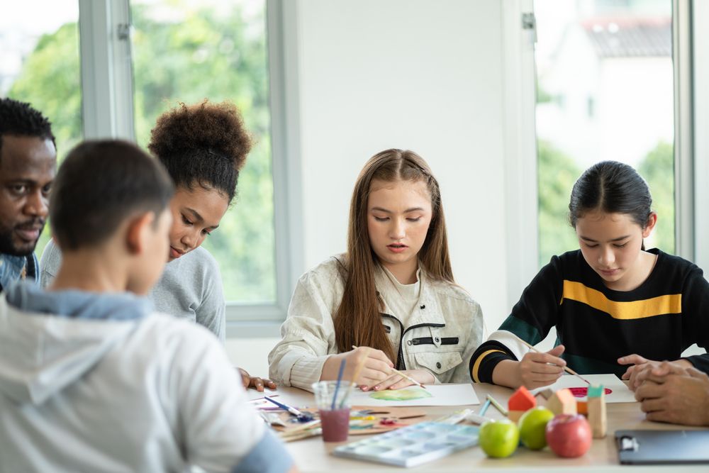Young students painting together in the classroom