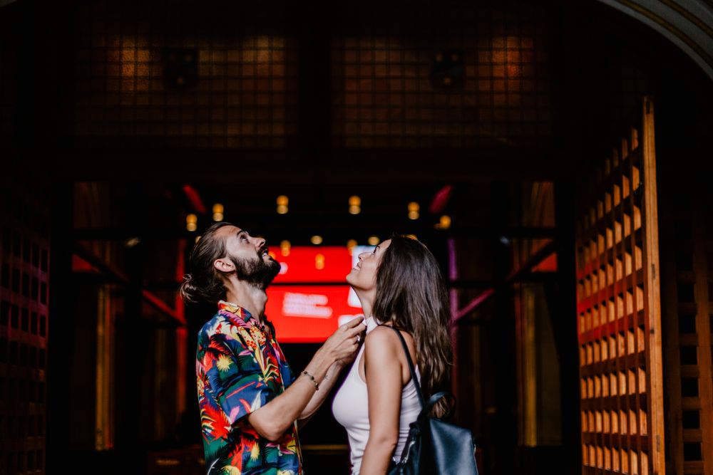 Laughing couple against building entrance