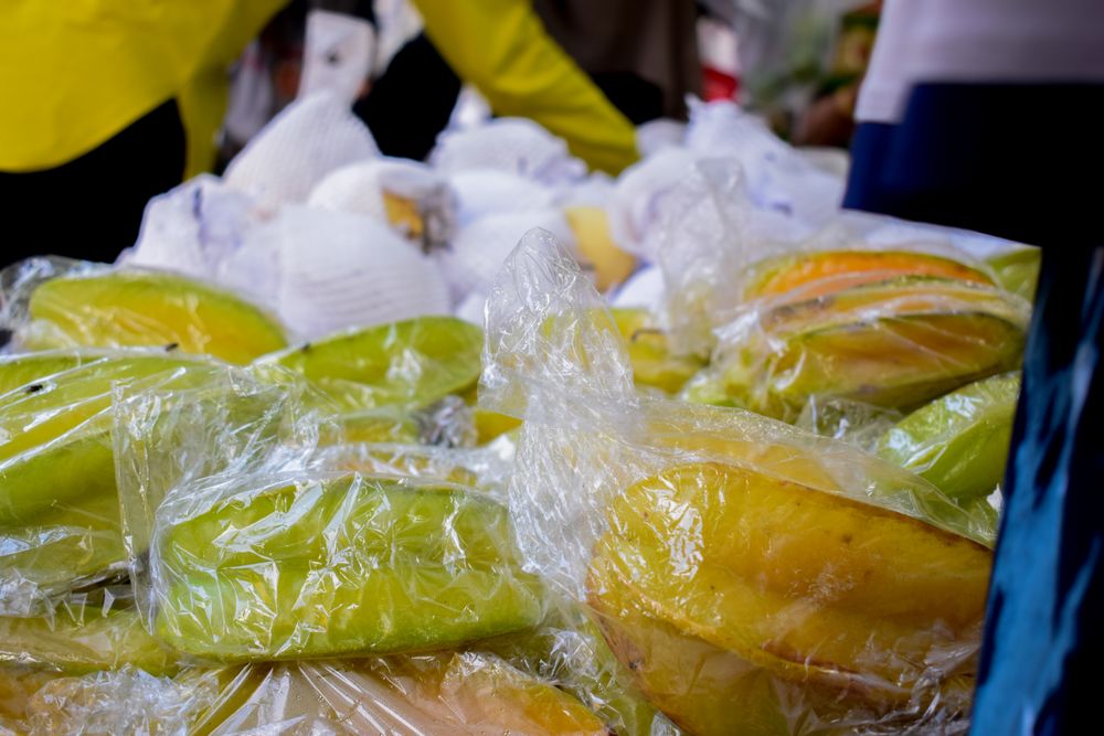 Star fruits wrapped and for sale in store