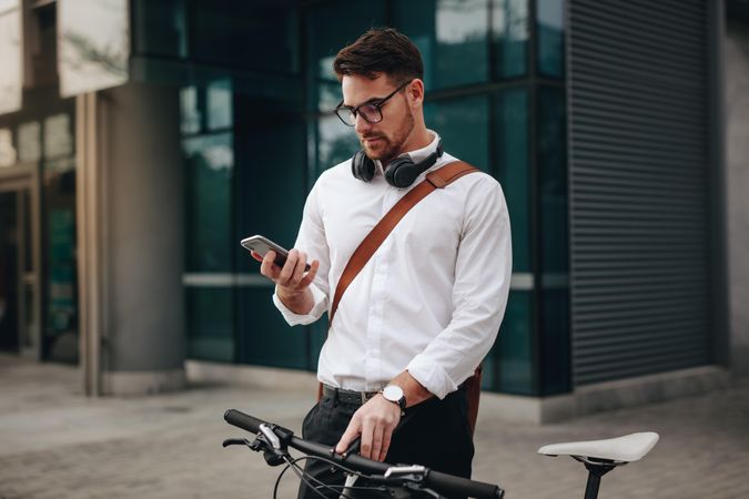 Businessman using mobile phone while going to office