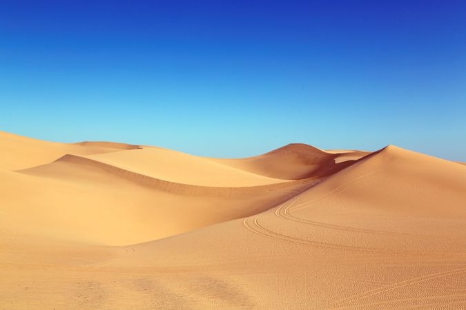 Sand dunes under blue sky