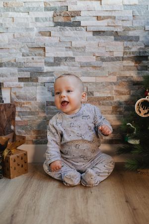 Cute baby playing with Christmas tree baubles