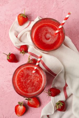 Composition with strawberry cocktails on pink table. Summer drink