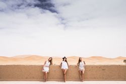 Women in white on desert landscape