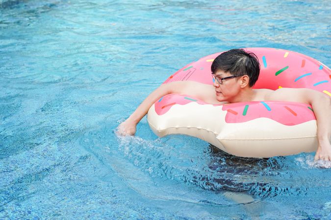 Asian man with inflatable swim ring