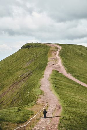 Person walking up a trail in the Brecon Beacons mountain range