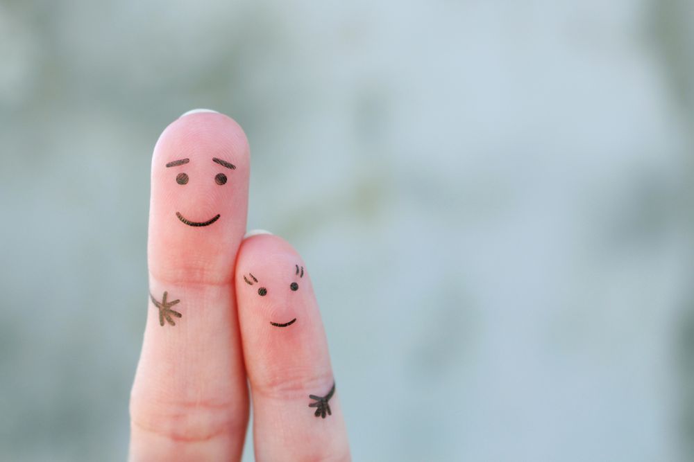 Fingers art of father hugs her daughter.