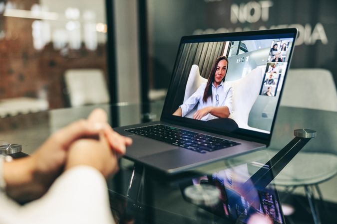 Black businesswoman on laptop screen  attending a virtual meeting in a modern workplace