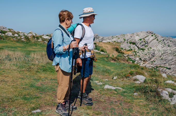 Older couple observing view on a hike