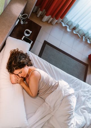 Woman dozing in bed after breakfast