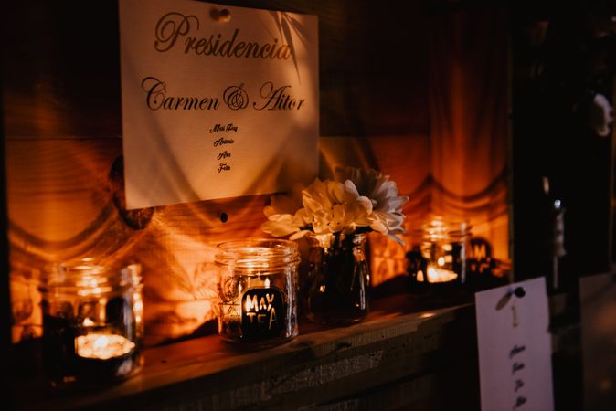 Wall with wedding decorations on shelves