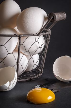 Eggs in a basket and a cracked egg