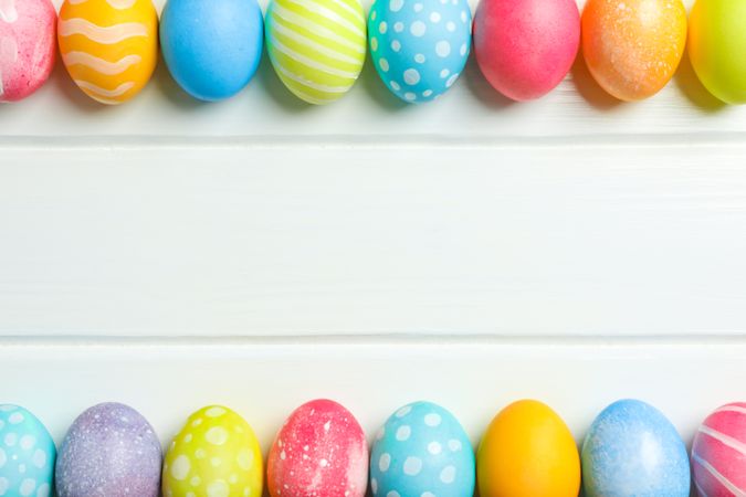 Decorative Easter eggs on wooden background, space for text. Top view