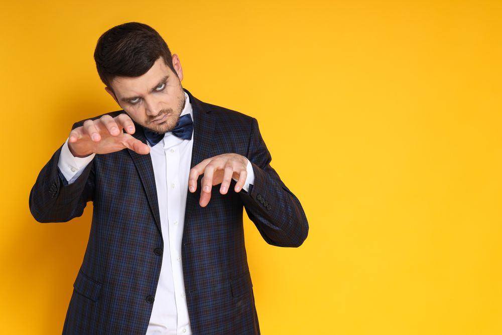 A man in a zombie costume on a yellow background