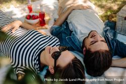 Cheerful couple on picnic relaxing at a park 4mn3ob