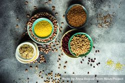 Top view of bowls of dried grains and legumes from pantry 5lVjkm