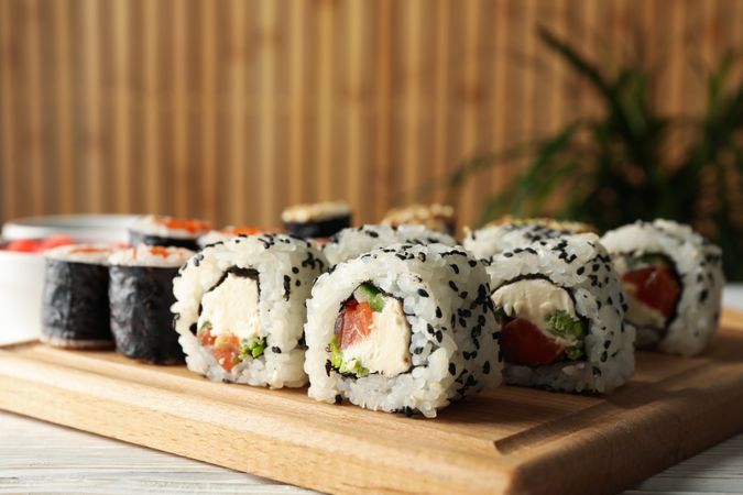 Delicious sushi rolls on wooden background, close up. Japanese food