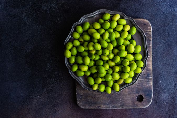 Plate of green Georgian tkemali fruit