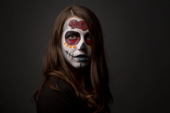 Young woman with creepy face paint