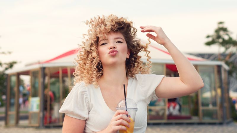 Woman with drink outdoors