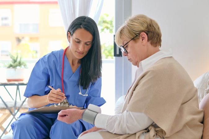 Physician against patient with tonometer during examination