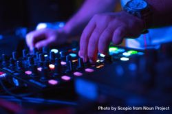 DJ playing music using audio mixer 0PW82b