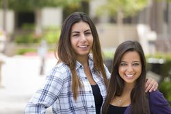 Female Students Carrying Backpacks on School Campus