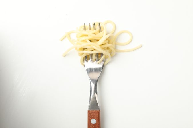 Fork with tasty pasta isolated on blank background