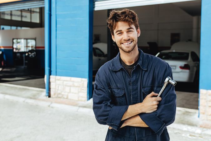 Professional auto mechanic in uniform with ratchet tool