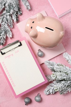 Concept of Christmas finance with piggy bank, top view