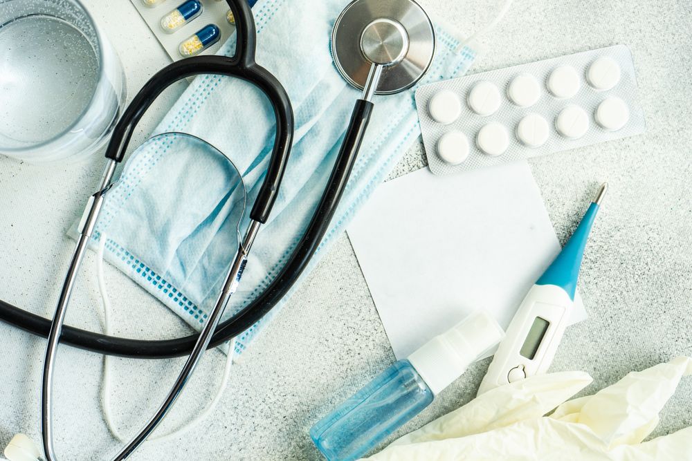 Top view of pills, thermometer and stethoscope in health care concept