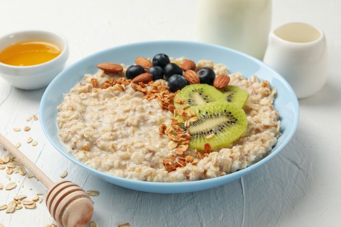 Composition with oatmeal with fruits on blank background