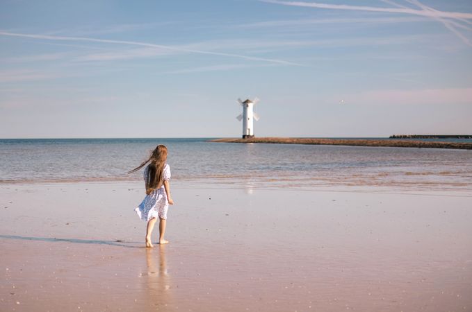 Adorable little girl with long hair in white dress